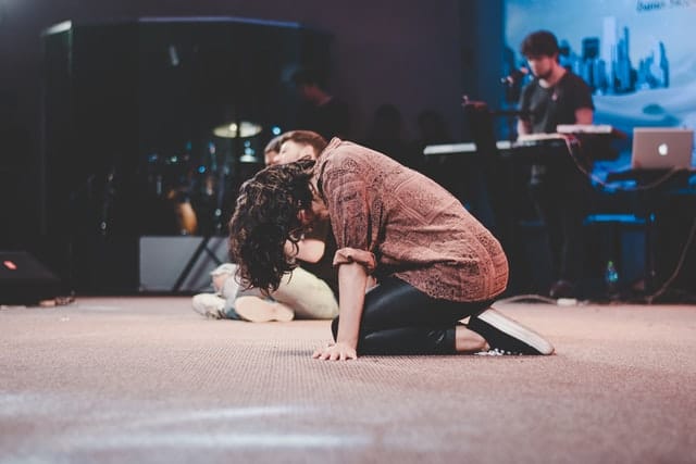 Woman sitting on the floor praying